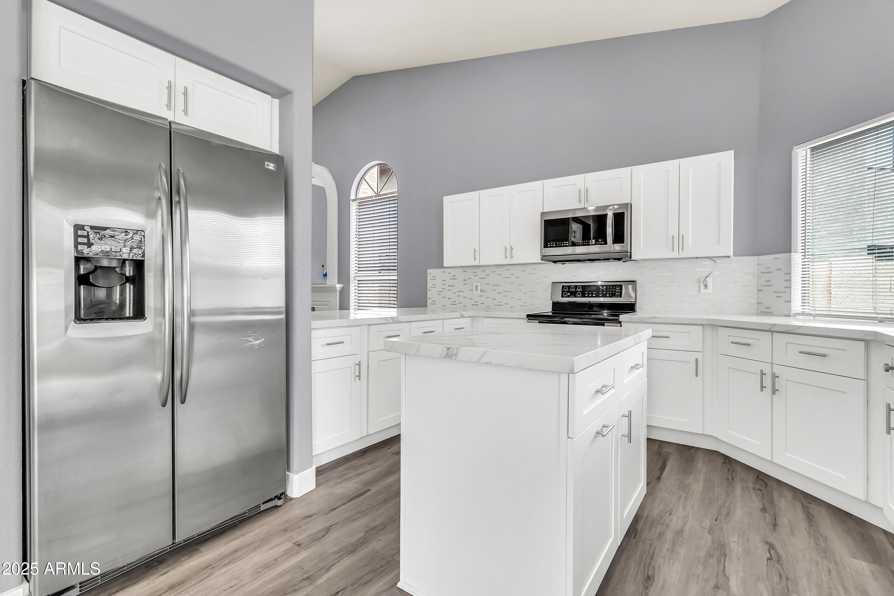 205 East Stacey Lane Tempe, AZ 85284 - Photo 10 of 63 a kitchen with white cabinets and stainless steel appliances