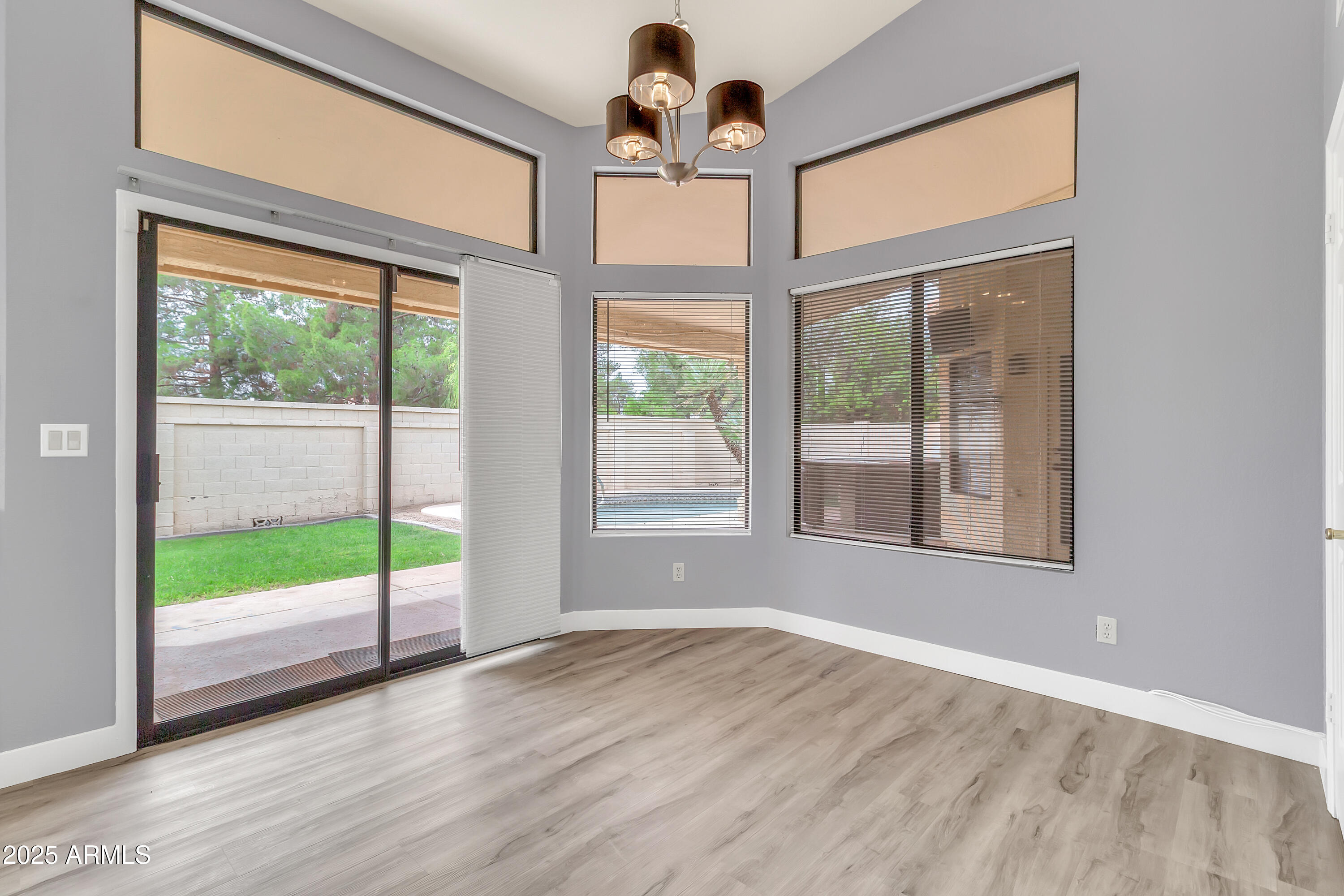 205 East Stacey Lane Tempe, AZ 85284 - Photo 15 of 63 a view of an empty room with wooden floor and a window