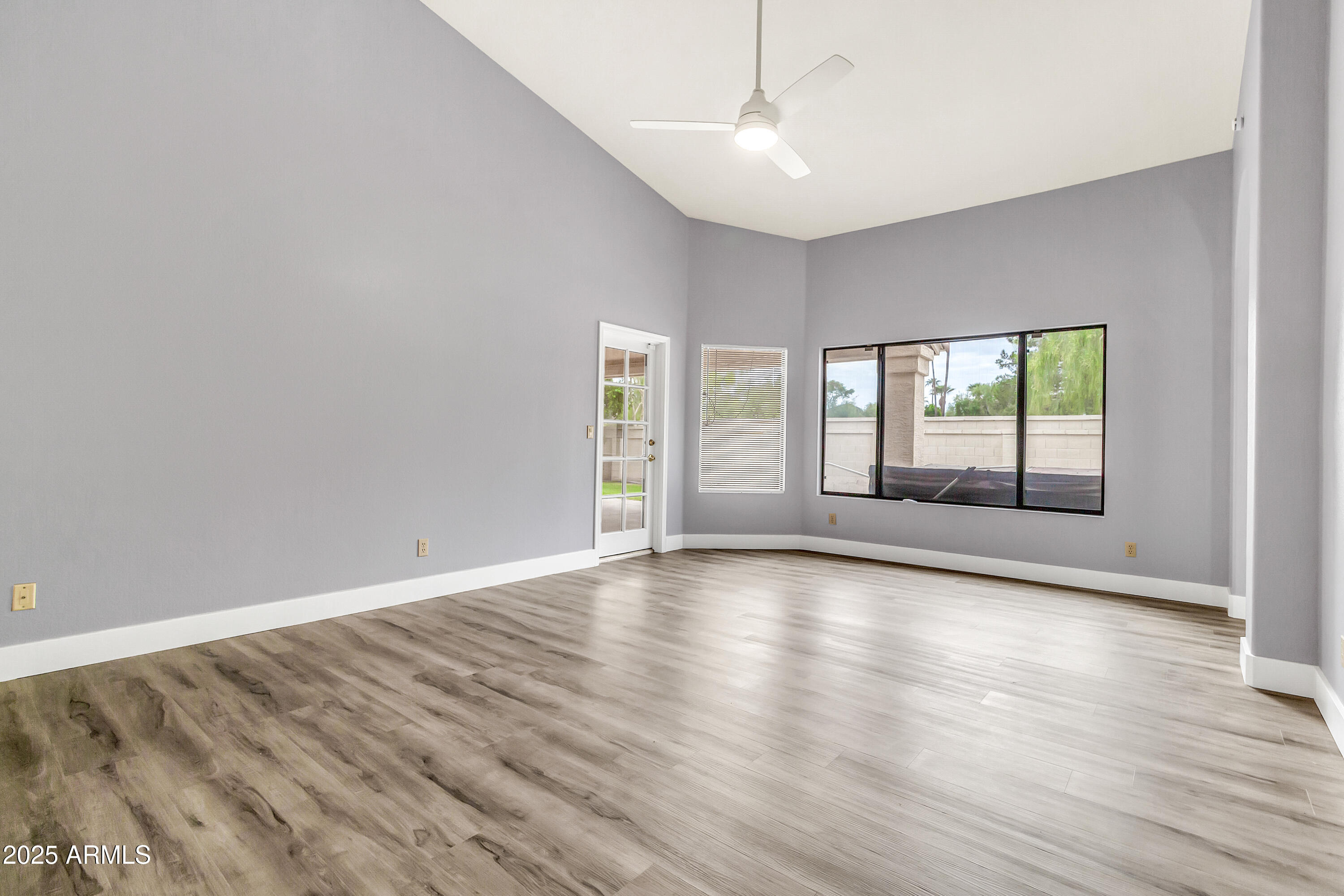 205 East Stacey Lane Tempe, AZ 85284 - Photo 17 of 63 an empty room with wooden floor and windows