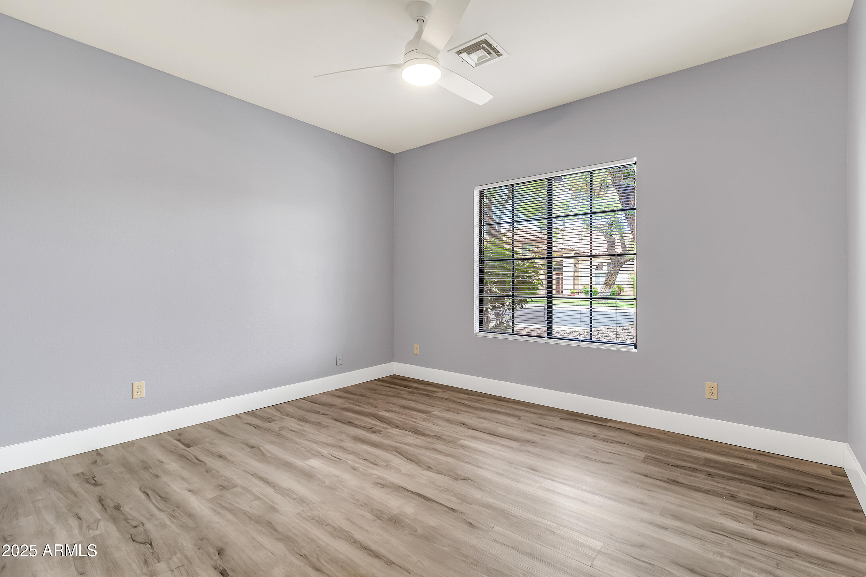 205 East Stacey Lane Tempe, AZ 85284 - Photo 28 of 63 an empty room with wooden floor and windows