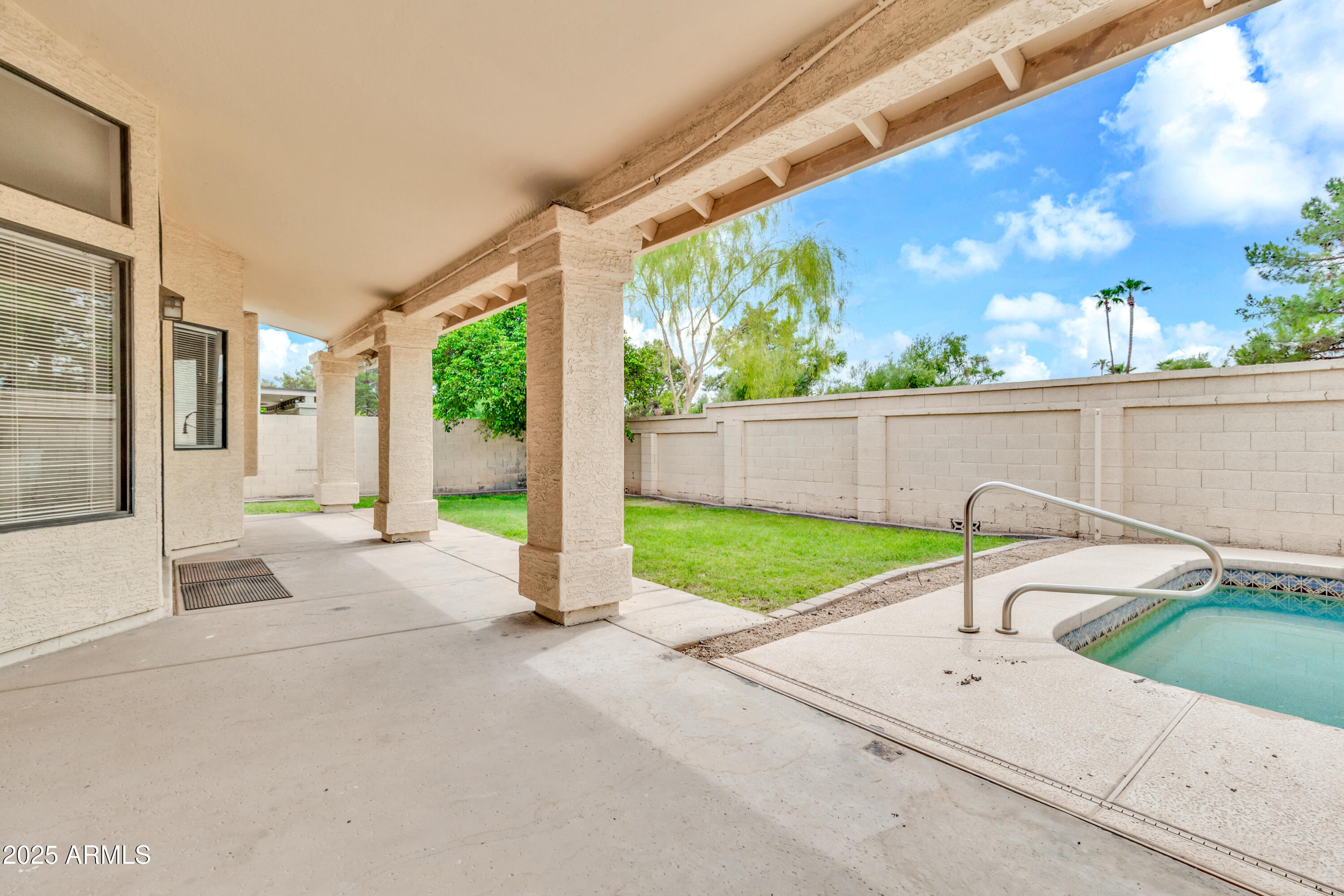 205 East Stacey Lane Tempe, AZ 85284 - Photo 39 of 63 a view of a patio with a table and chairs and floor to ceiling window