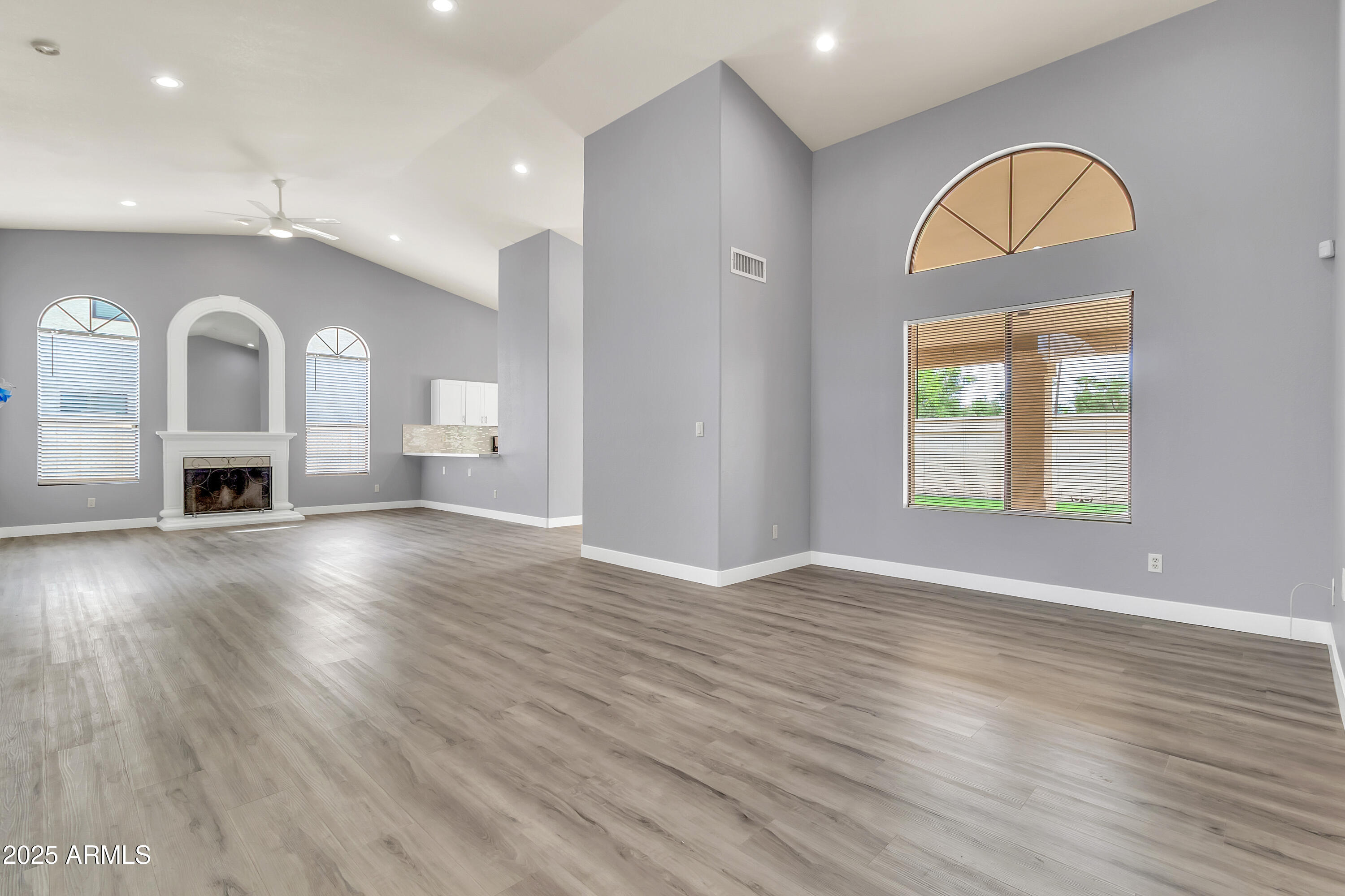 205 East Stacey Lane Tempe, AZ 85284 - Photo 5 of 63 a view of empty room with a fireplace and wooden floor