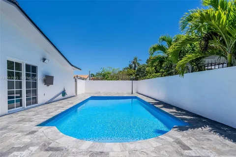 a view of a backyard with plants and tub