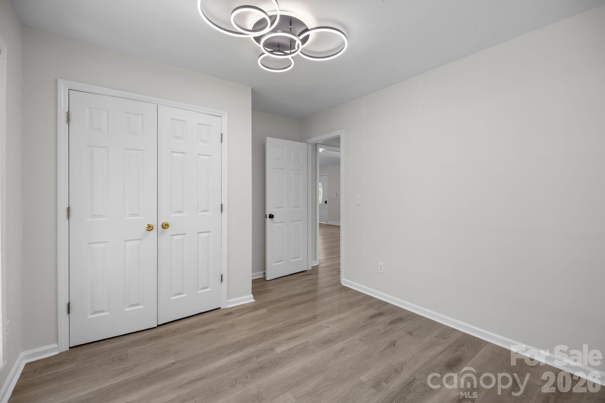 1012 Crescent Way Wingate, NC 28174 - Photo 11 of 20 a view of an empty room with wooden floor