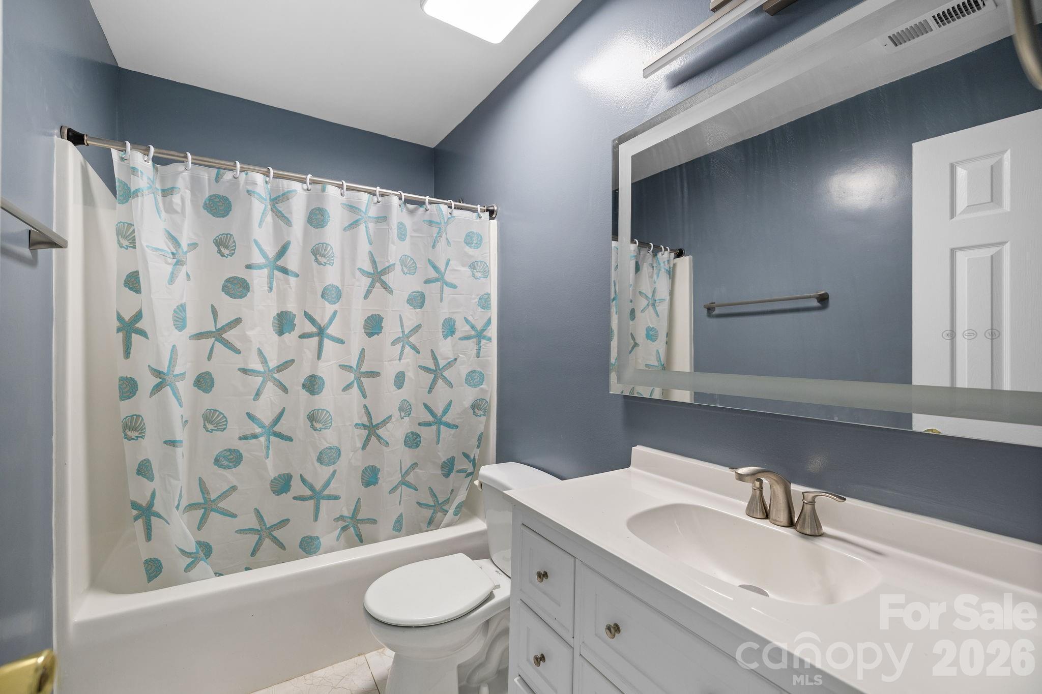 1012 Crescent Way Wingate, NC 28174 - Photo 12 of 20 a bathroom with a sink a toilet and shower curtain