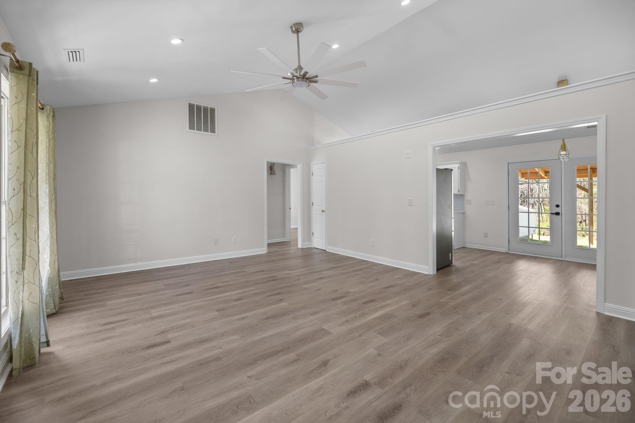 1012 Crescent Way Wingate, NC 28174 - Photo 3 of 20 a view of an empty room with wooden floor and a window