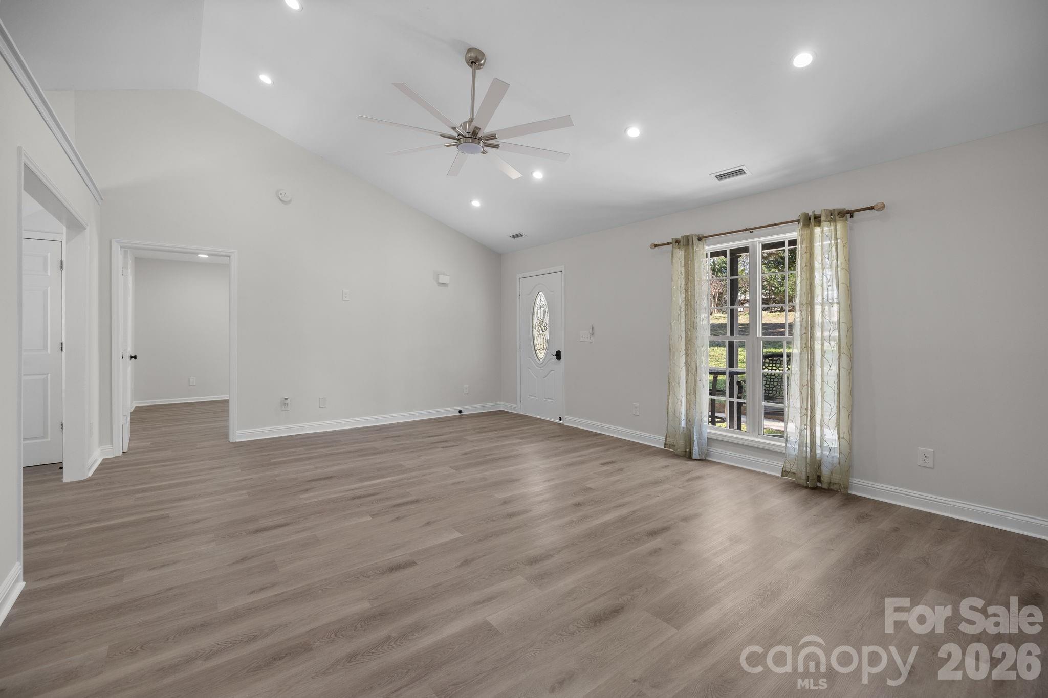 1012 Crescent Way Wingate, NC 28174 - Photo 4 of 20 a view of an empty room with a window and wooden floor