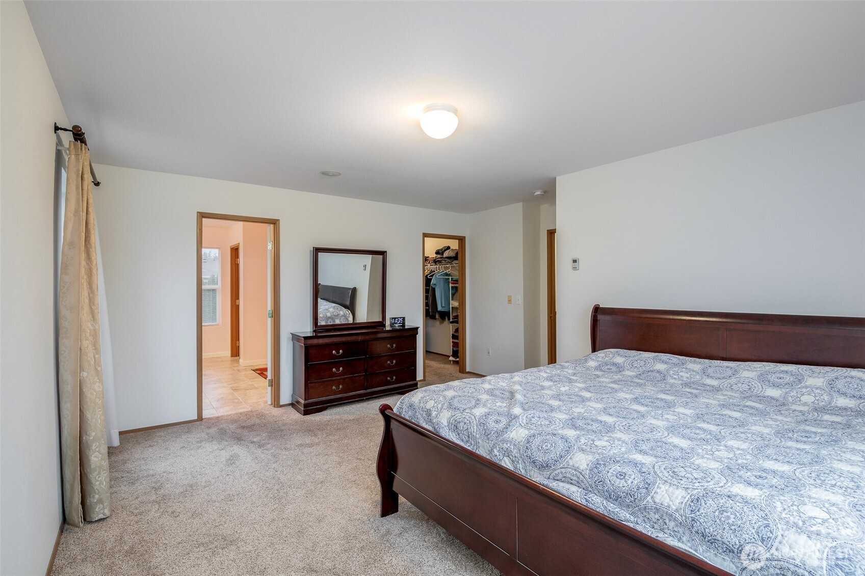 17008 Southeast 183rd Place Renton, WA 98058 - Photo 18 of 27 a bedroom with a large bed and dresser