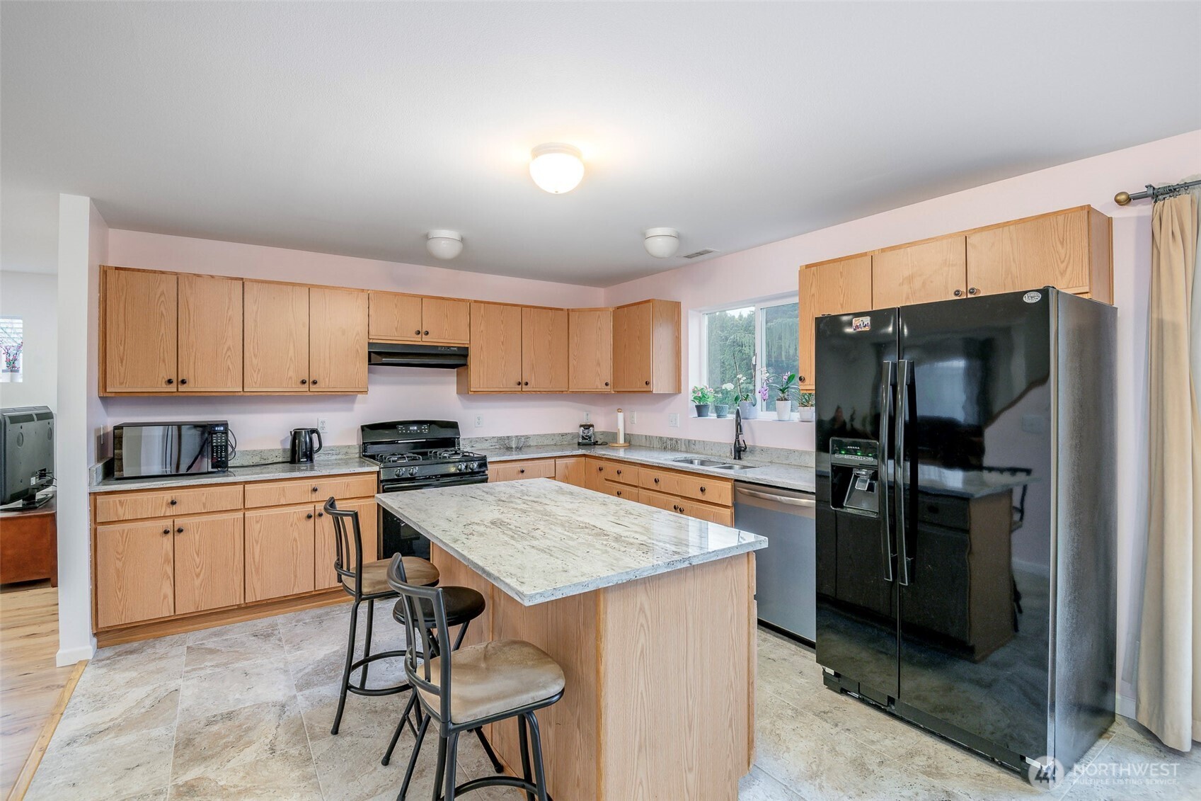 17008 Southeast 183rd Place Renton, WA 98058 - Photo 9 of 27 a kitchen with a refrigerator a stove a sink and a cabinets
