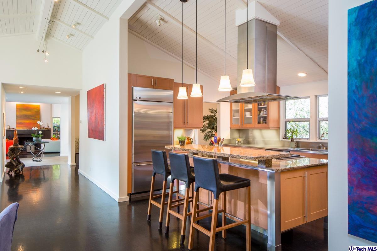 900 Hillcrest Place Pasadena, CA 91106 - Photo 11 of 40 a kitchen with stainless steel appliances a dining table chairs stove and cabinets