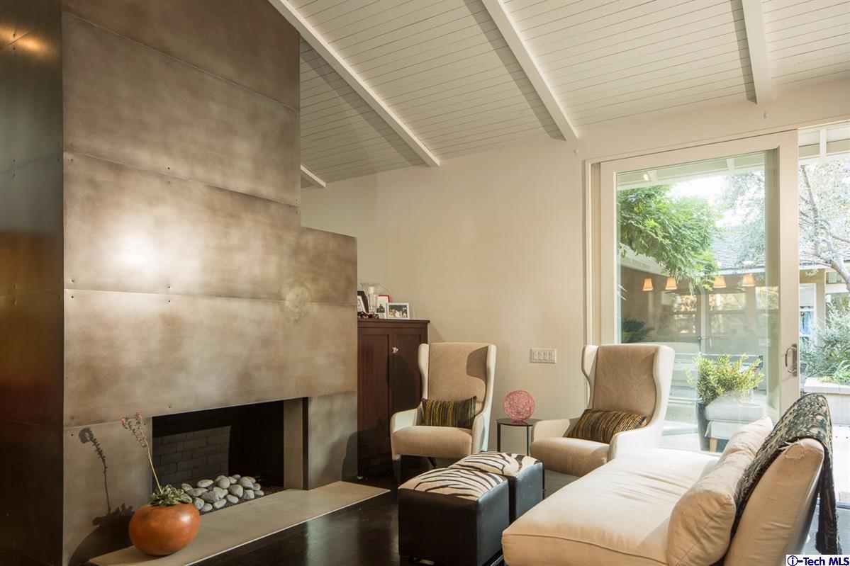 900 Hillcrest Place Pasadena, CA 91106 - Photo 13 of 40 a living room with furniture a fireplace and a floor to ceiling window