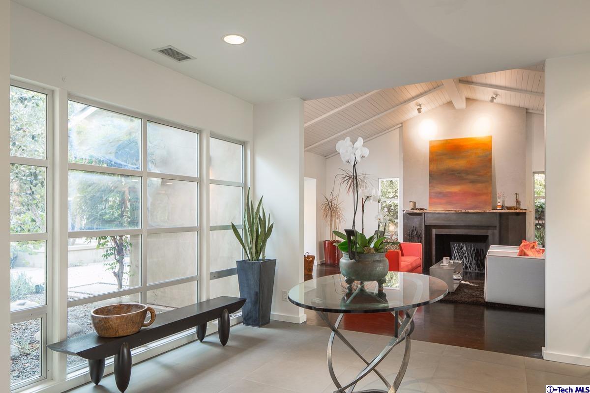 900 Hillcrest Place Pasadena, CA 91106 - Photo 3 of 40 a living room with furniture a fireplace and a table