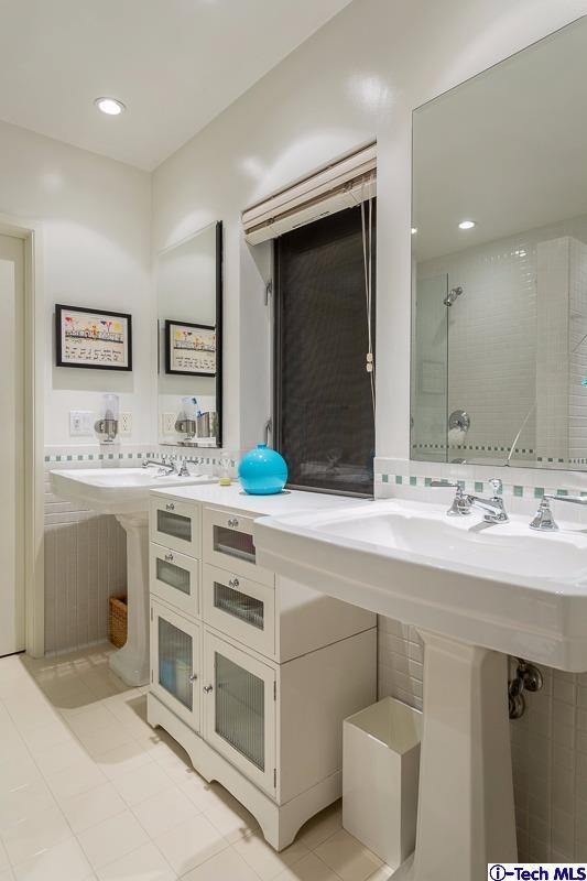900 Hillcrest Place Pasadena, CA 91106 - Photo 22 of 40 a bathroom with a sink double vanity and a mirror