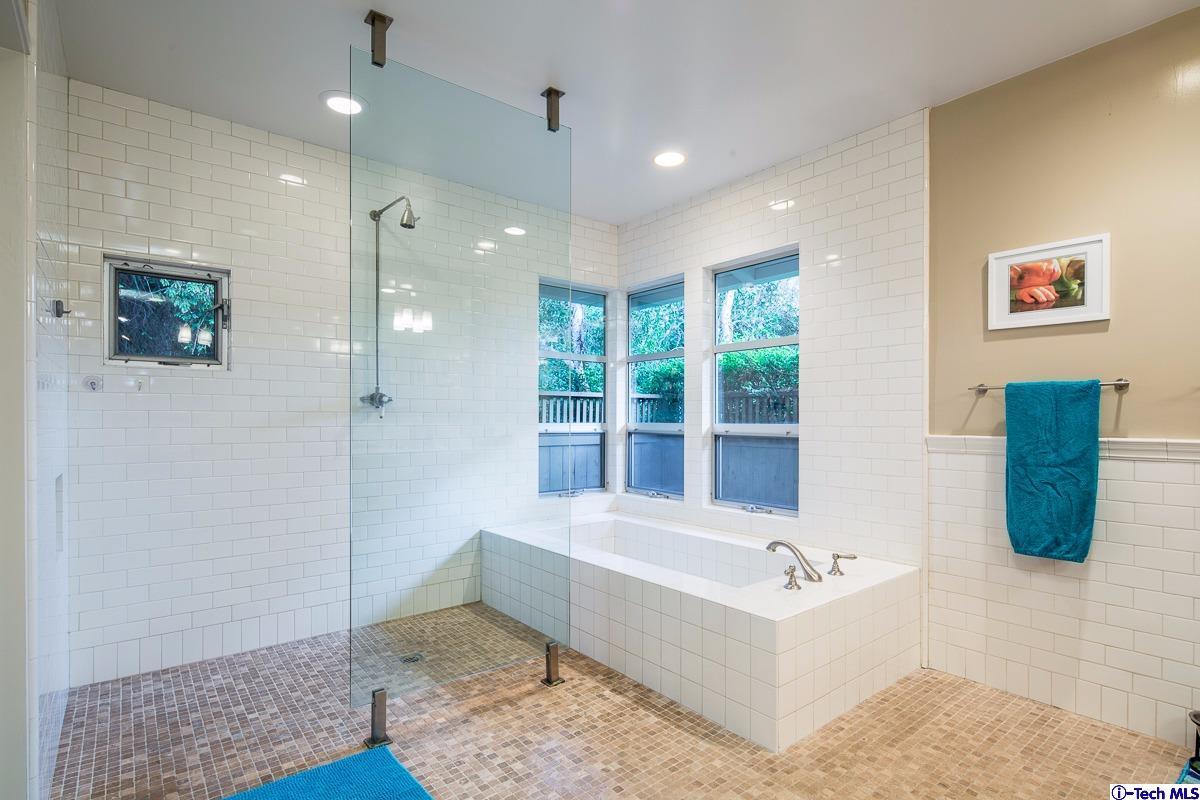 900 Hillcrest Place Pasadena, CA 91106 - Photo 26 of 40 a bathroom with a tub a potted plant and a shower