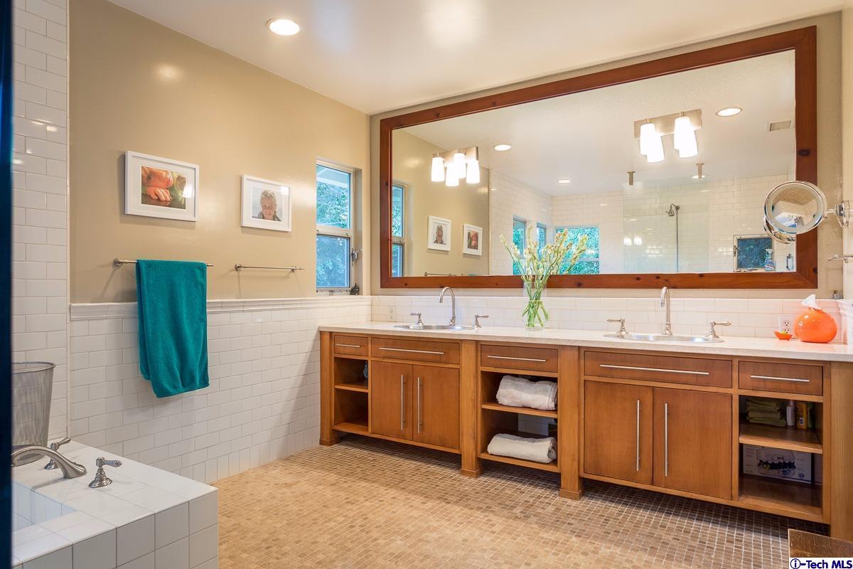 900 Hillcrest Place Pasadena, CA 91106 - Photo 27 of 40 a spacious bathroom with a double vanity sink and a mirror
