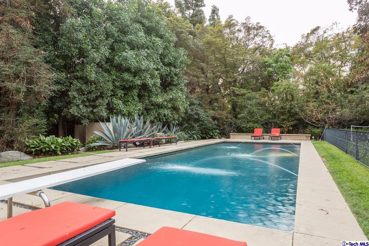 900 Hillcrest Place Pasadena, CA 91106 - Photo 32 of 40 a view of a swimming pool with a lounge chairs