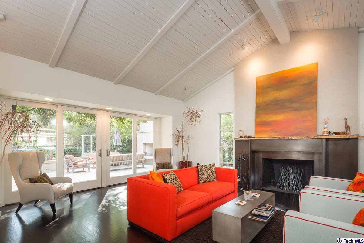 900 Hillcrest Place Pasadena, CA 91106 - Photo 5 of 40 a living room with furniture a fireplace and floor to ceiling windows