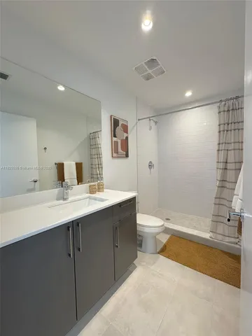 a bathroom with a tub a sink and mirror