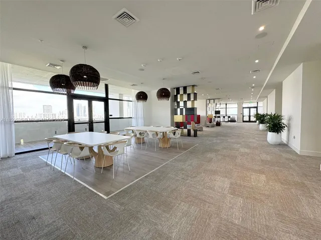 a very nice looking room with a large window and chandelier