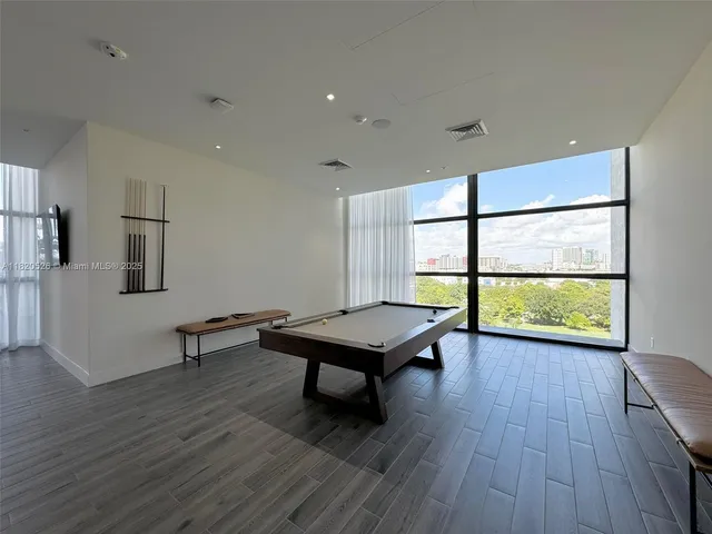 a room with furniture wooden floor and a window