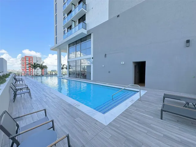 a view of a living room and kitchen with furniture and wooden floor