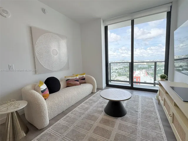 a living room with a couch and a large window