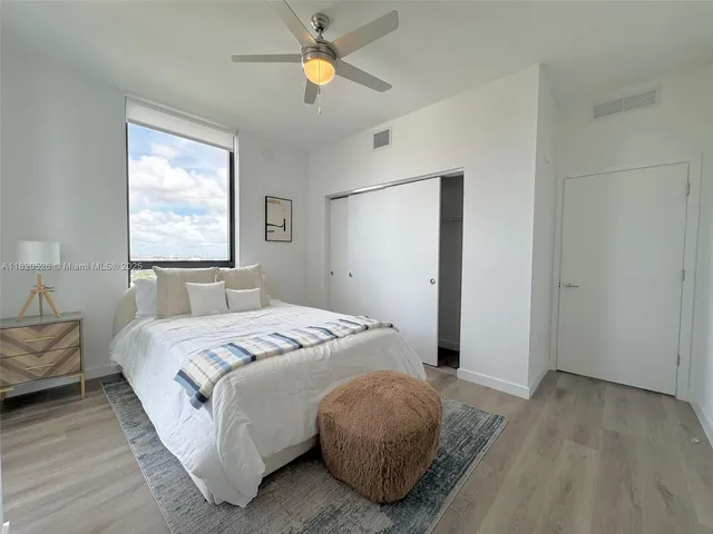 a bedroom with a bed and a window