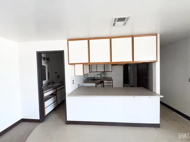 a large white kitchen with a large window