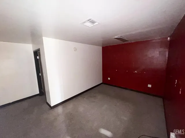 a view of a livingroom with a refrigerator and a microwave