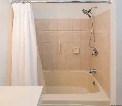 a bathroom with a shower and a bath tub
