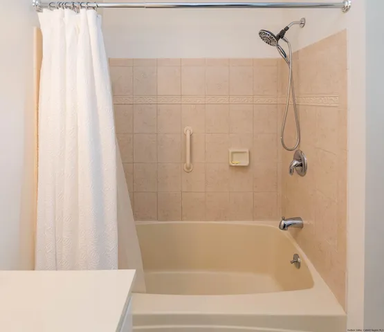a bathroom with a shower and a bath tub