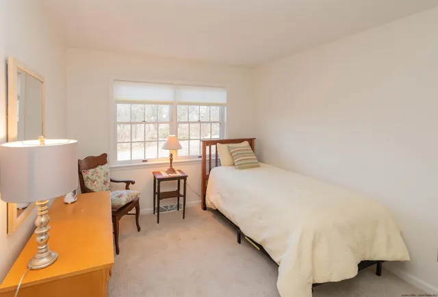 a bedroom with a bed and a table chair