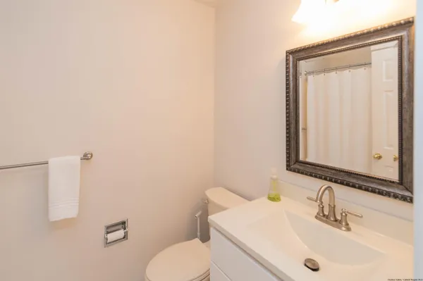 a bathroom with a sink a toilet and mirror