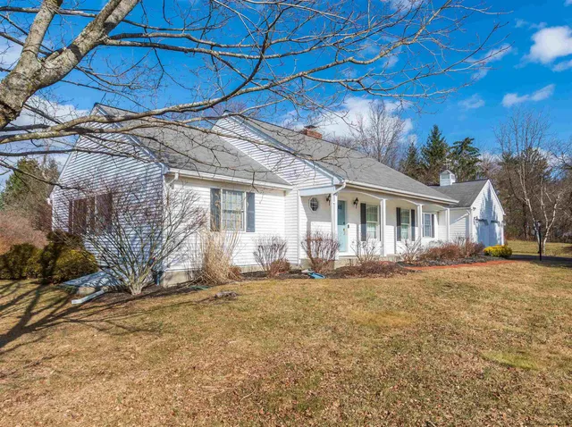 a backyard of a house with yard and outdoor seating