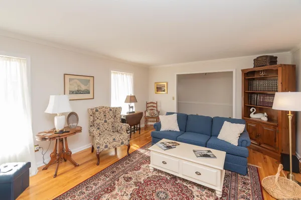 a living room with furniture a rug and a window