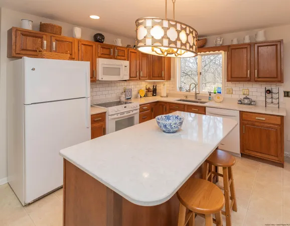 a kitchen with a table chairs stove and refrigerator