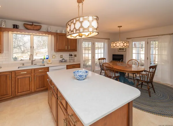 a kitchen with a stove a table and chairs in it