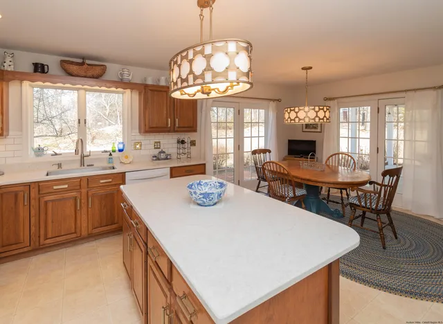 a kitchen with a stove a table and chairs in it