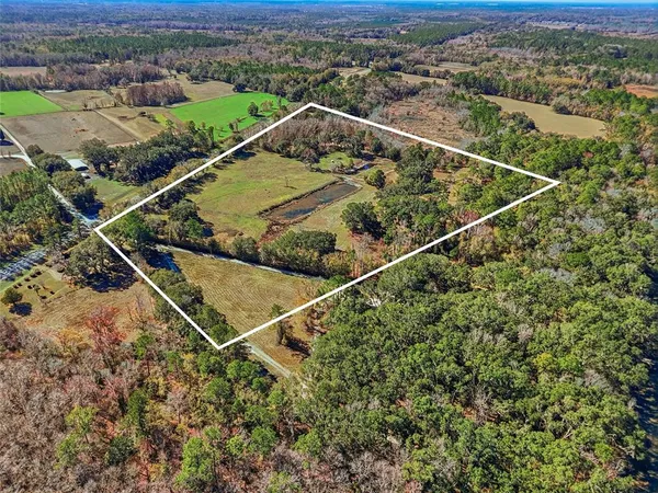 an aerial view of a houses with a yard