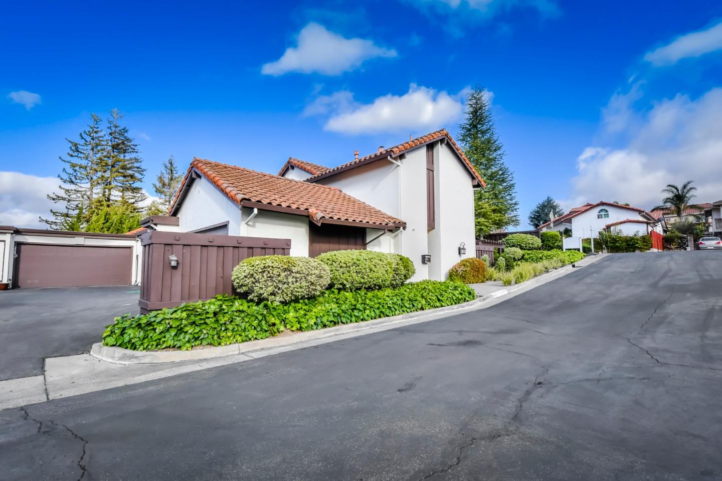22059 McClellan Road Cupertino, CA 95014 - Photo 1 of 40 a front view of a house with a yard and garage