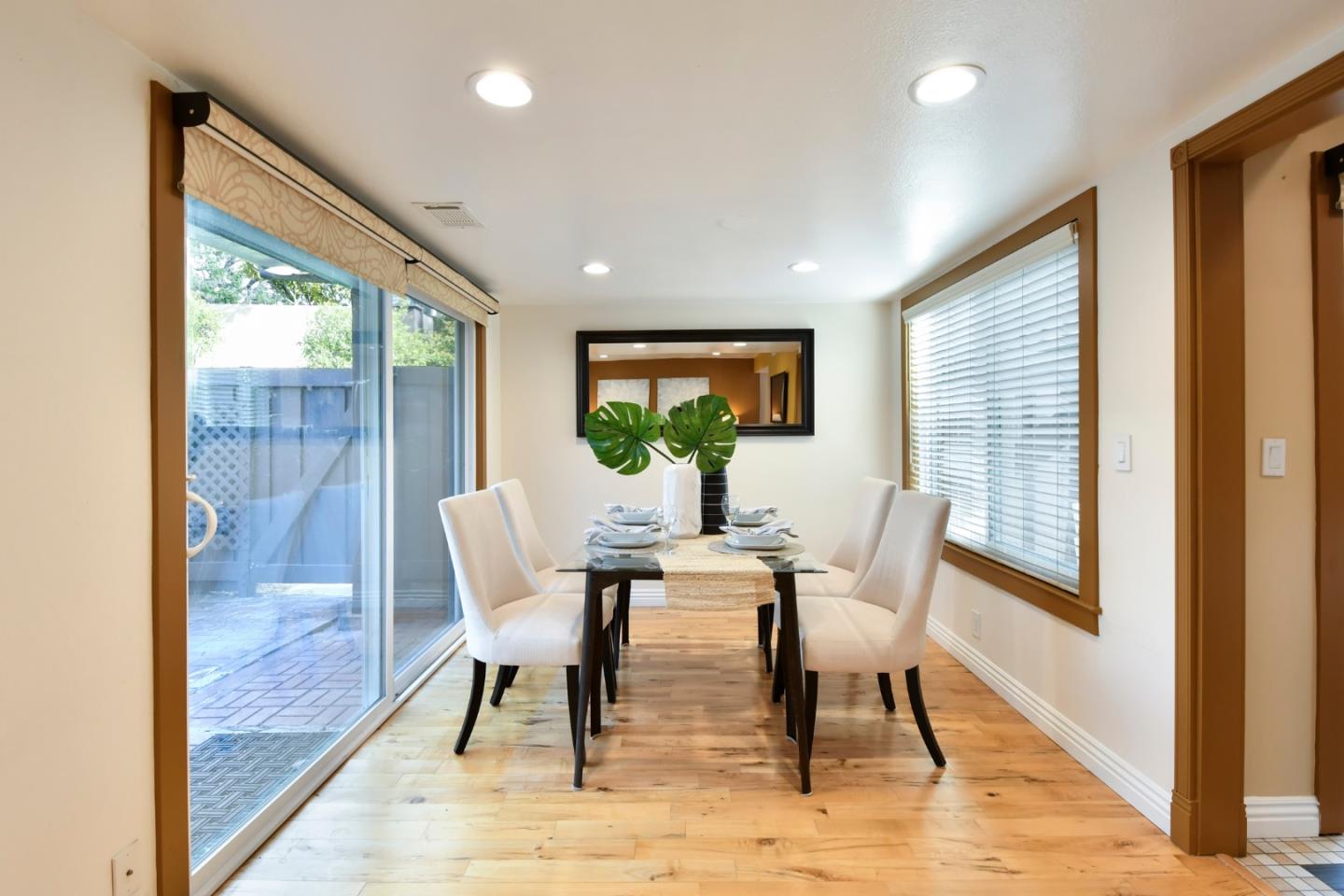 22059 McClellan Road Cupertino, CA 95014 - Photo 11 of 40 a dining room with furniture a rug and wooden floor