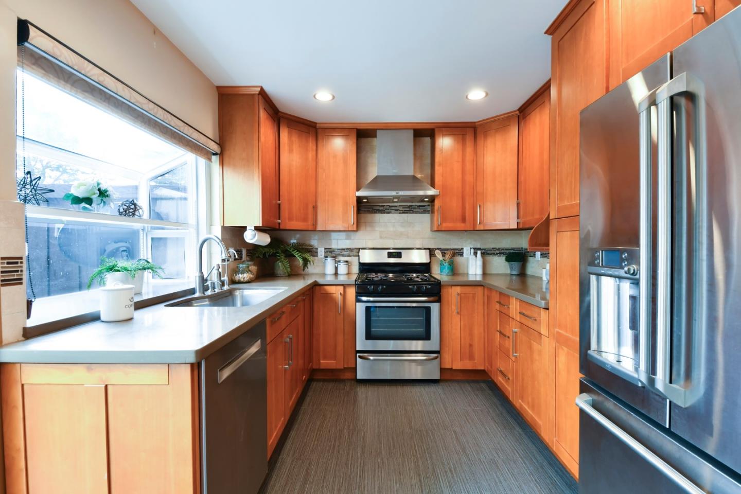 22059 McClellan Road Cupertino, CA 95014 - Photo 16 of 40 a kitchen with stainless steel appliances granite countertop a stove a sink and a refrigerator