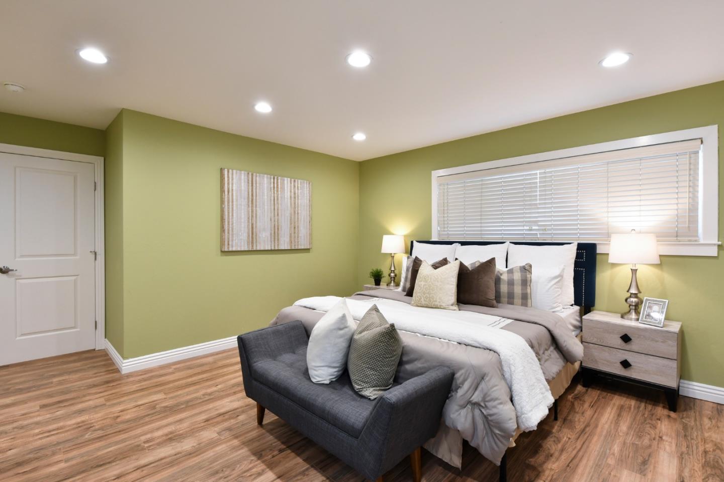 22059 McClellan Road Cupertino, CA 95014 - Photo 21 of 40 a bedroom with a bed and wooden floor