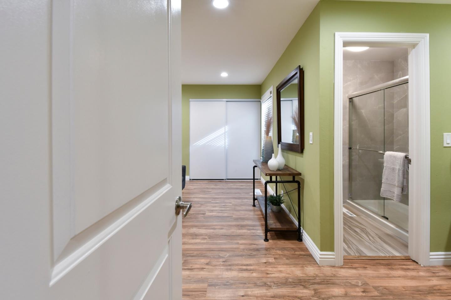 22059 McClellan Road Cupertino, CA 95014 - Photo 23 of 40 a hallway with wooden floor fireplace and livingroom