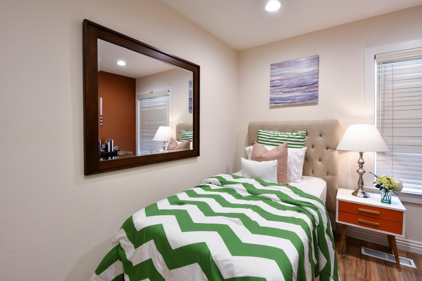 22059 McClellan Road Cupertino, CA 95014 - Photo 26 of 40 a bedroom with a bed and painting on the wall