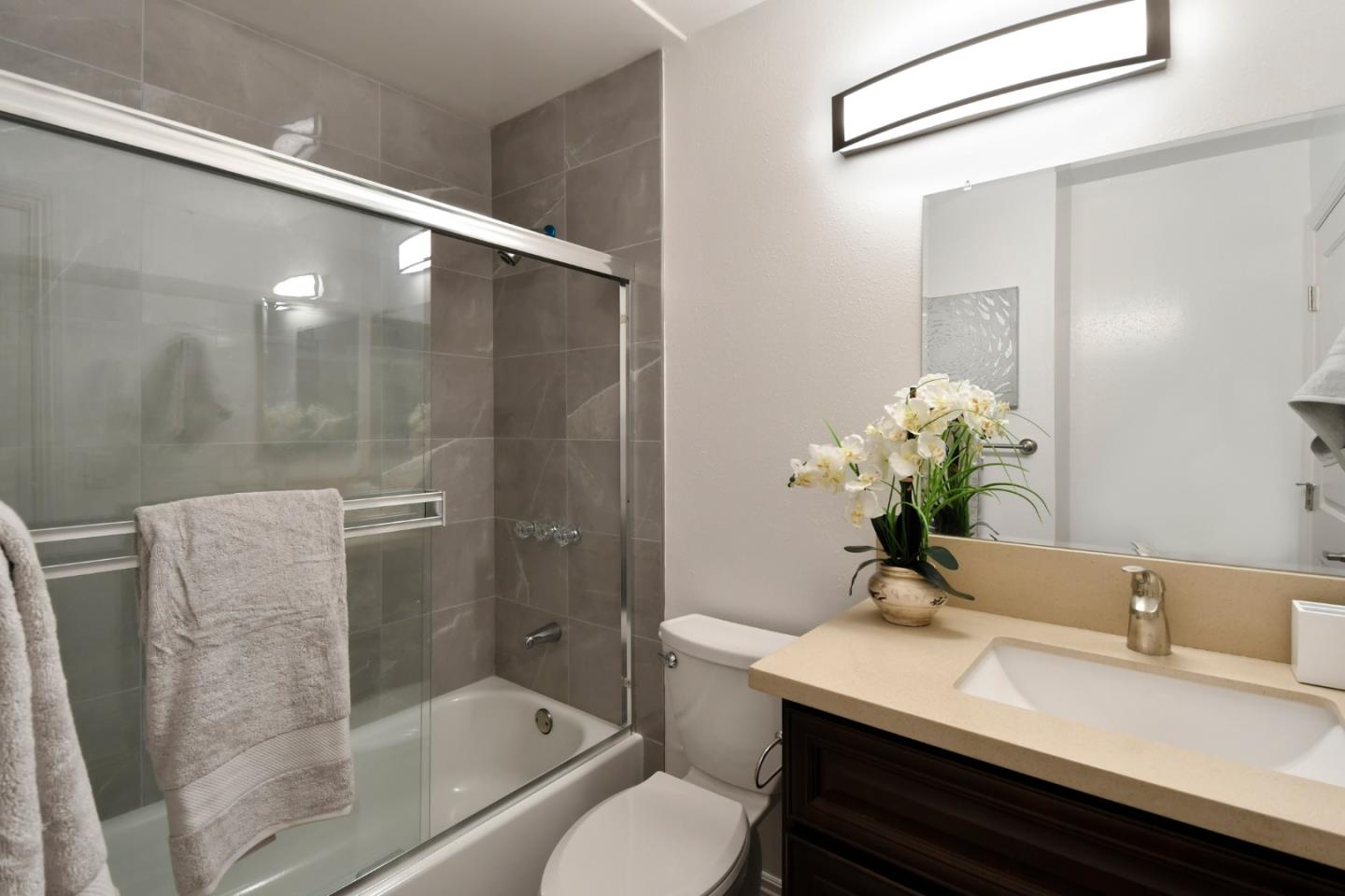 22059 McClellan Road Cupertino, CA 95014 - Photo 28 of 40 a bathroom with a granite countertop sink a toilet and shower