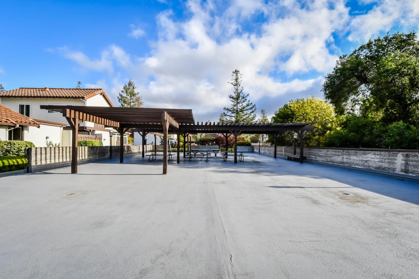 22059 McClellan Road Cupertino, CA 95014 - Photo 37 of 40 a view of a patio with a table and chairs under an umbrella