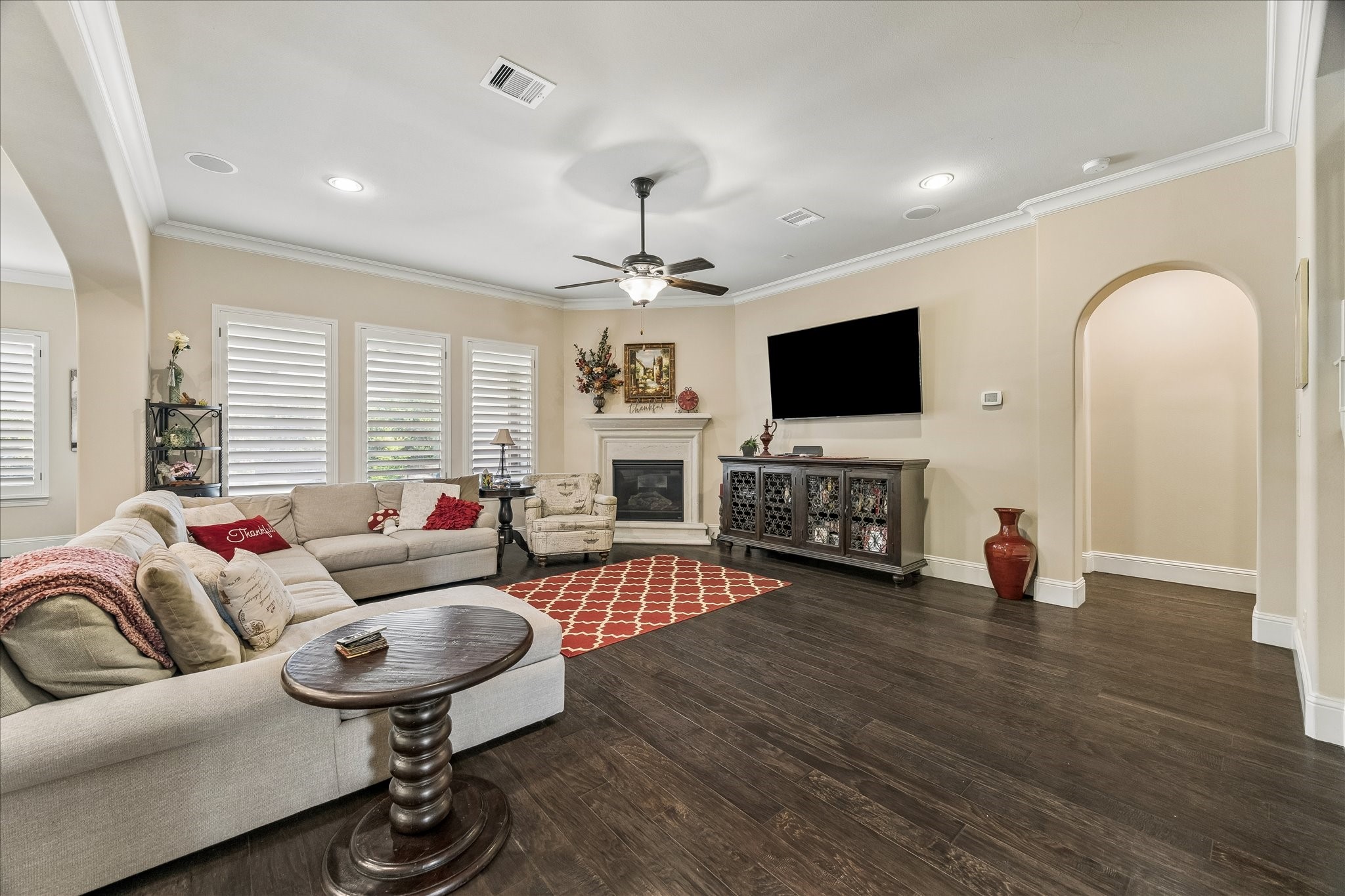 3 Tiburon Court Spring, TX 77389 - Photo 14 of 37 This spacious living room features dark hardwood floors, a cozy fireplace, ample natural light all completing the inviting atmosphere.