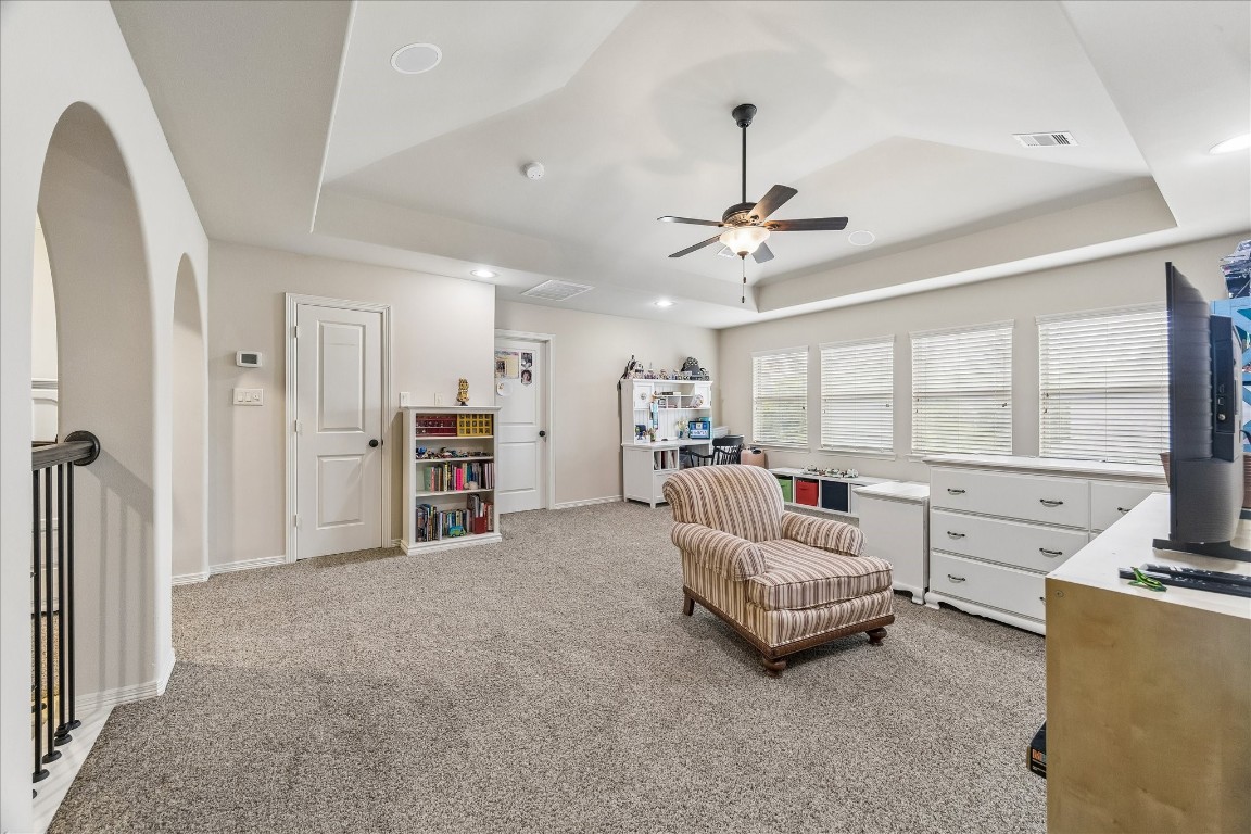 3 Tiburon Court Spring, TX 77389 - Photo 20 of 35 Gameroom features a row of large windows providing ample natural light. It boasts a ceiling fan and recessed lighting, making it ideal for a family or game room.