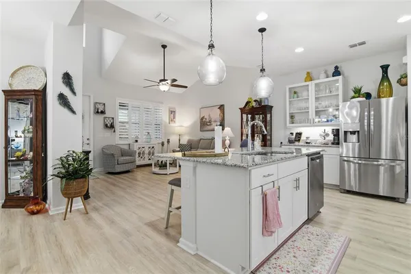 a kitchen with sink cabinets and refrigerator
